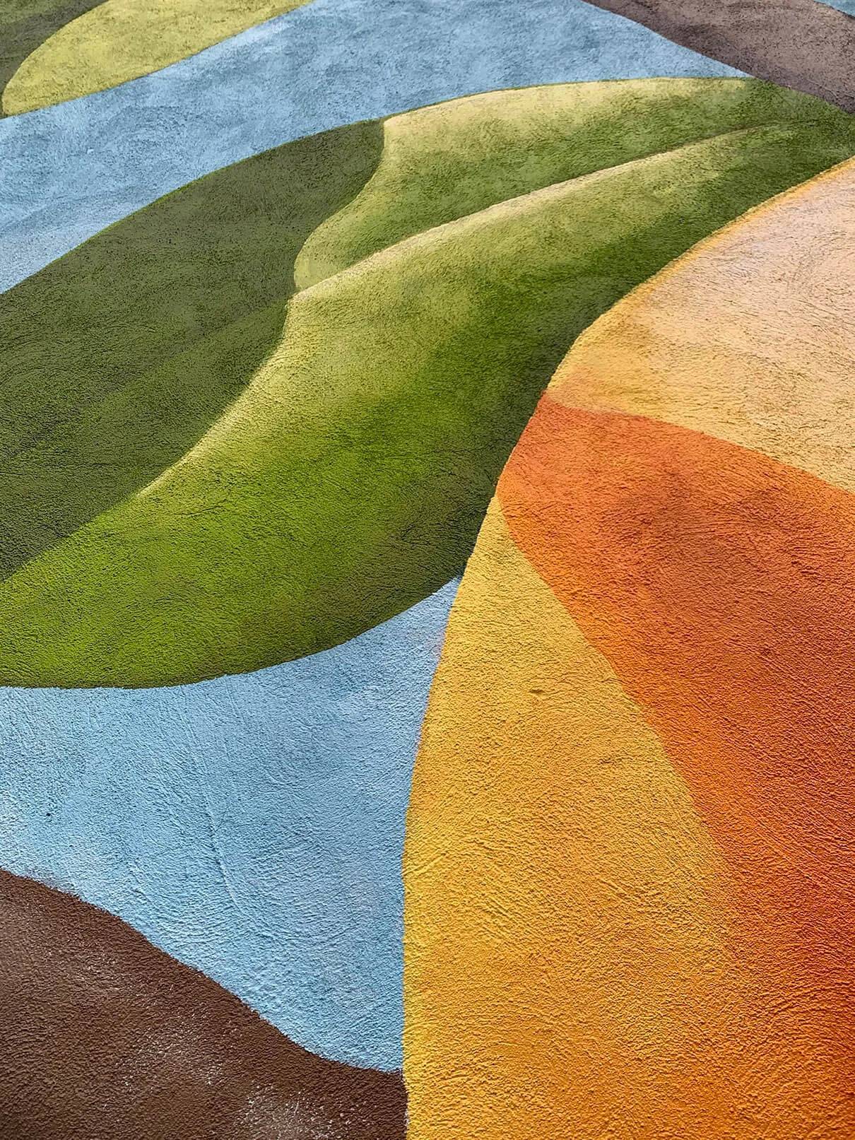 Close-up of a painted orange and its leaf